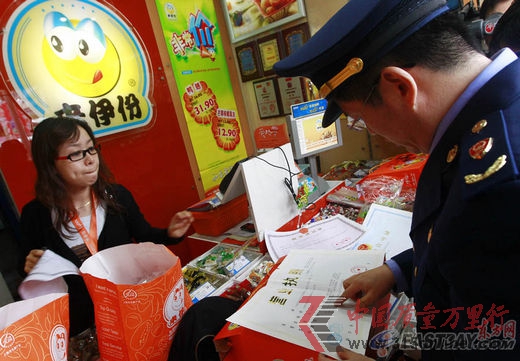 上海市工商工作人員正在檢查來伊份1477號門店,營業(yè)執(zhí)照等相關證明。